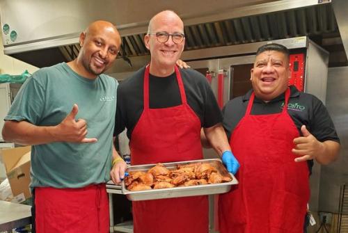 Luam Wersom, Larry J Snyder, and co-worker preparing the Love Lahaina Luau event buffet at Mojoto's in Seattle, Washington.