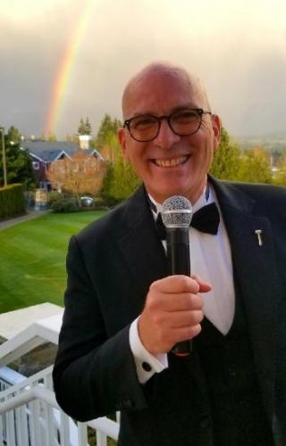 Larry J. Snyder capturing the moment of a memorable rainbow in the background during an event.